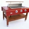 Rockwell By Caliber 60 Inch Propane Gas Grill On Cherry Wood Table - Red